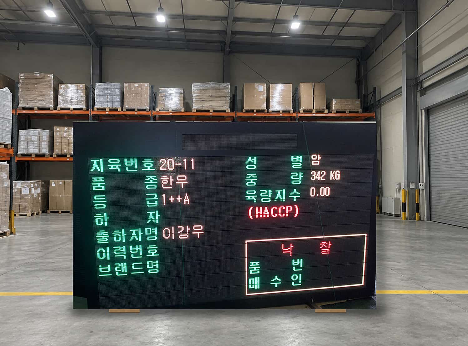 가축 경매장 LED 전광판에 지육번호·품종·등급·중량과 낙찰 정보가 표시된 장면
